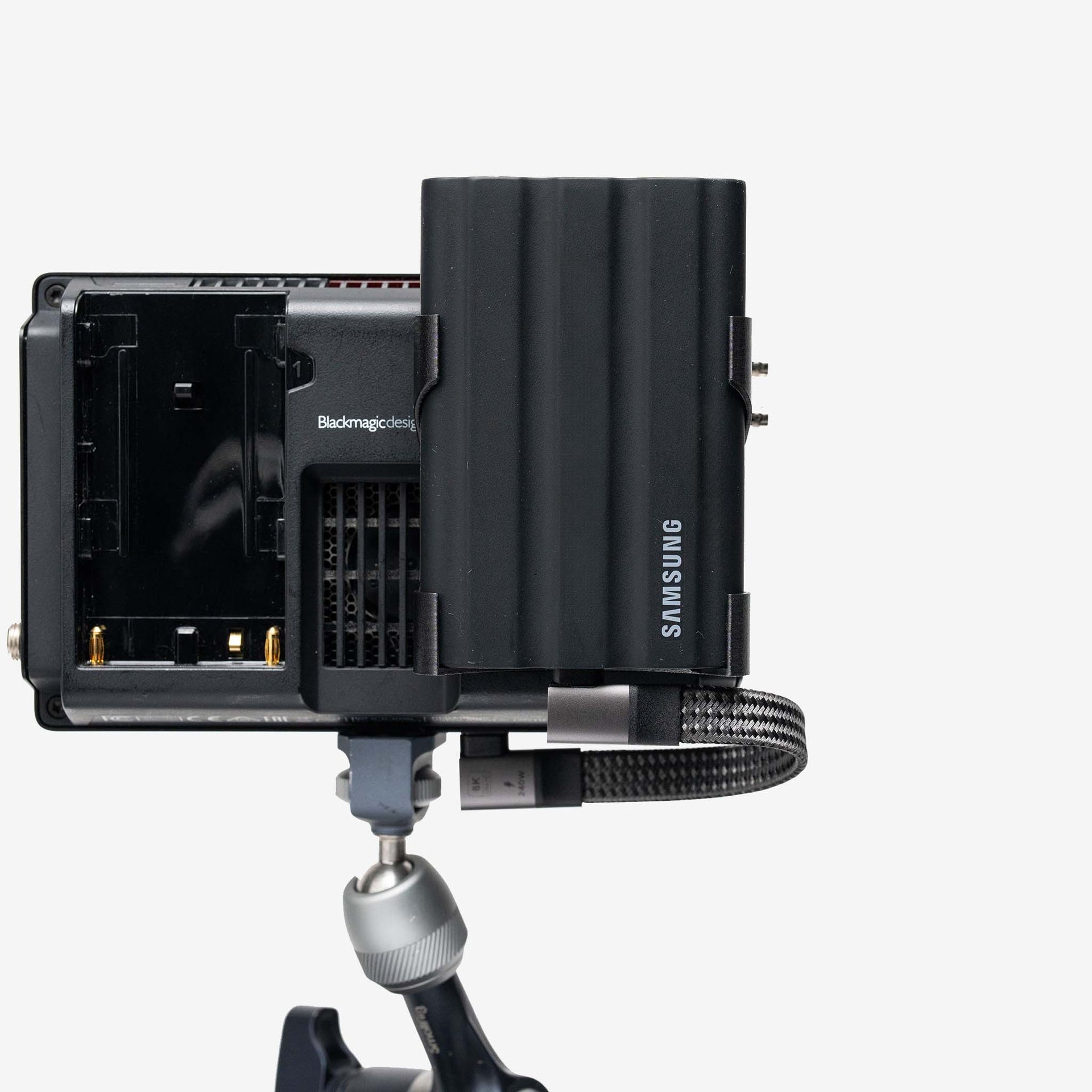 Black RAWMOUNT attached to camera housing with Samsung media and connected 90-degree SYNC™ cable for secure workflow integration