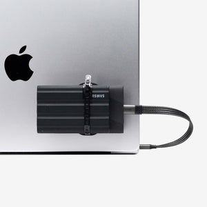 Universal SCREENMOUNT securely attached to a laptop holding a Samsung external drive to prevent dangling drives.