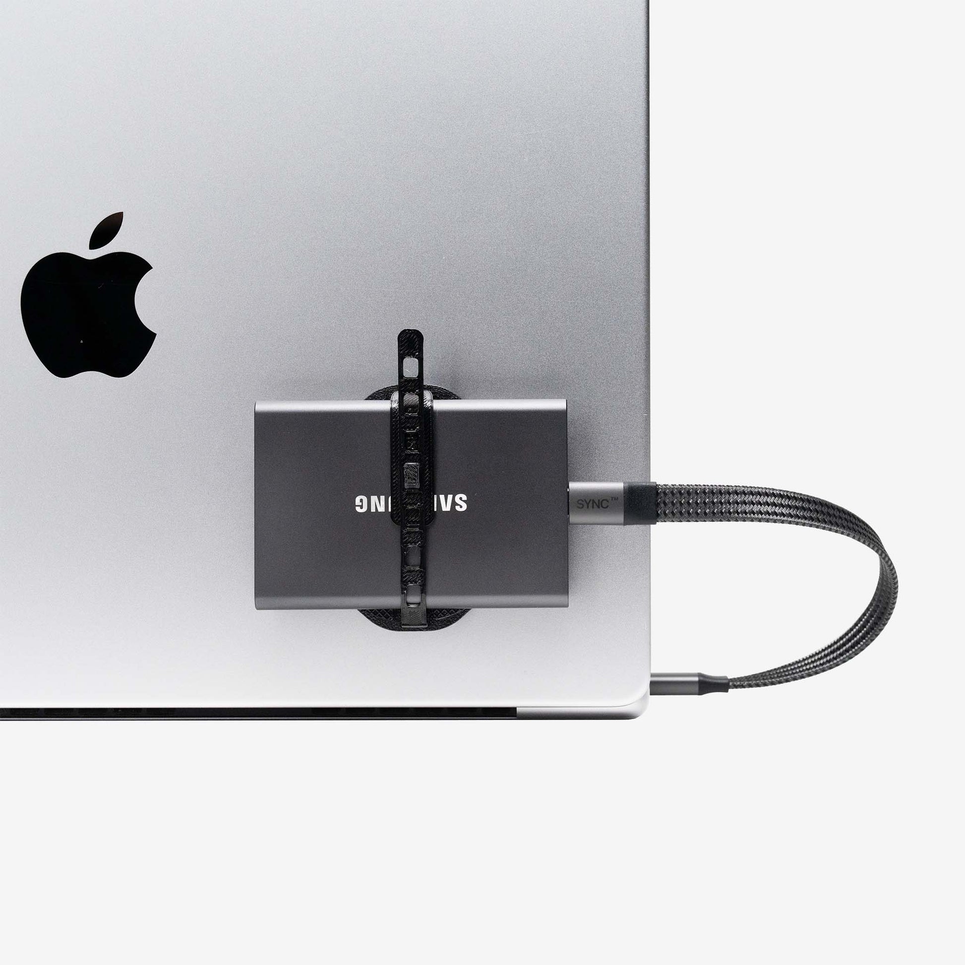 Samsung external drive secured to a laptop with a universal SCREENMOUNT to prevent dangling drives