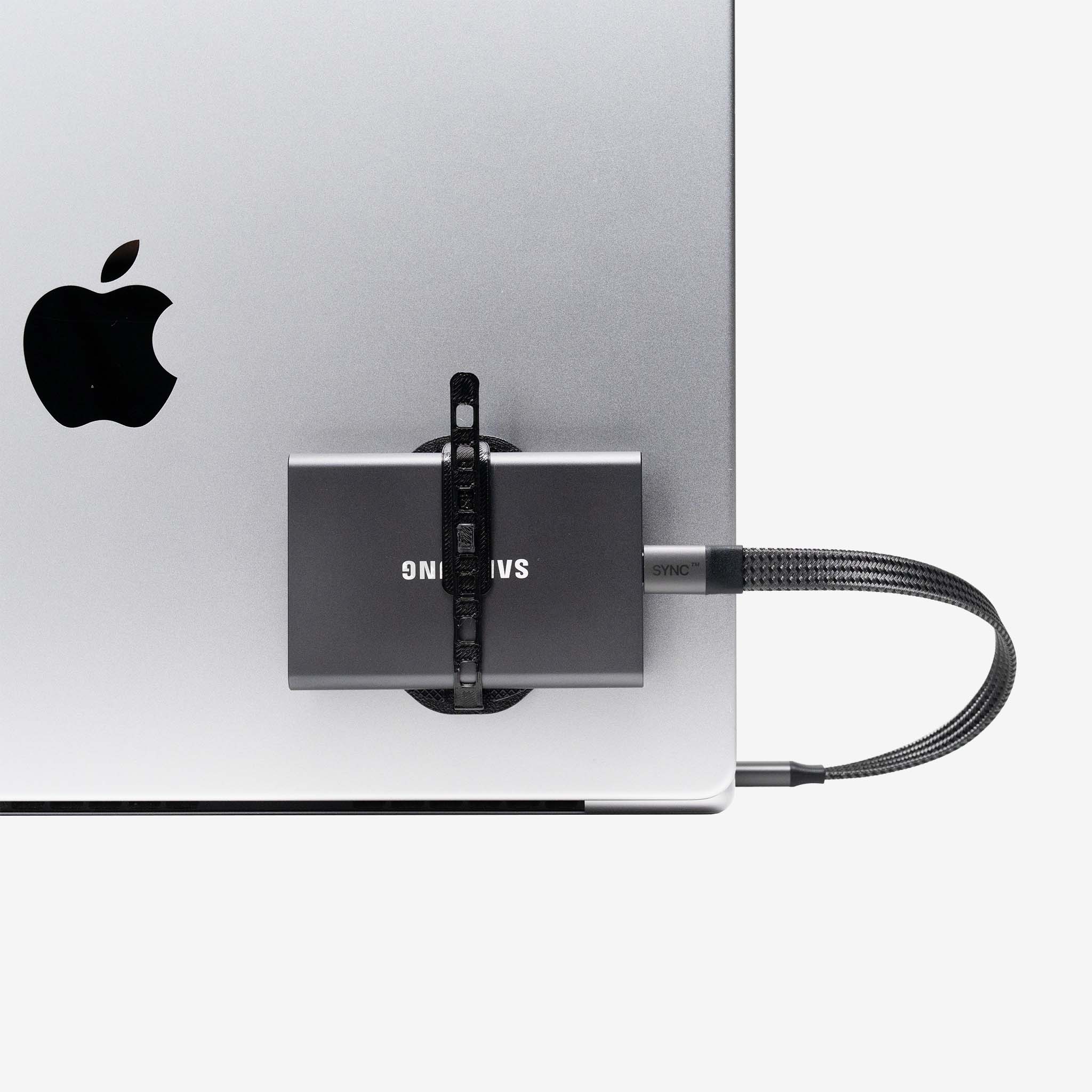 Samsung external drive secured to a laptop with a universal SCREENMOUNT to prevent dangling drives